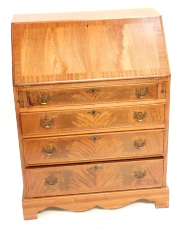 A flame mahogany and cross banded bureau, the fall flap opening to reveal two drawers and six recesses, over four long graduated drawers, raised on bracket feet, 104cm high, 73cm wide, 43cm deep.