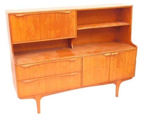 An S Form teak sideboard, the top with a drop down drinks cabinet, flanked by a single shelf, over two long drawers flanked by a pair of cupboard doors, raised on turned legs, 117cm high, 151cm wide, 43cm deep.