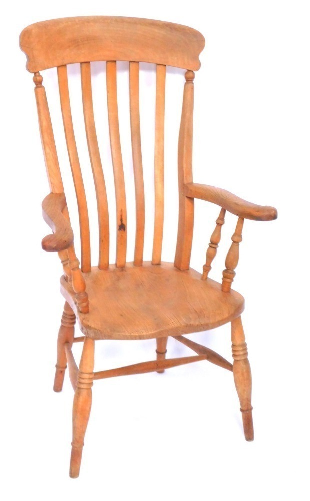 A Victorian oak and elm lath back kitchen chair, raised on turned legs ...