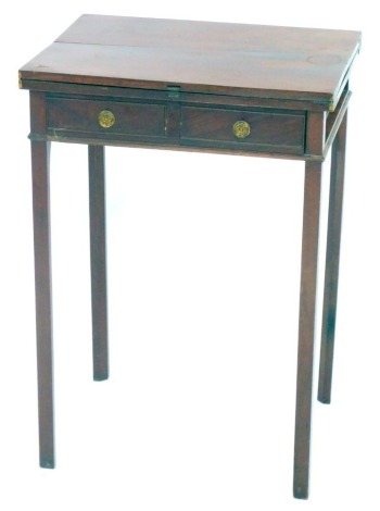 An Edwardian mahogany fold over occasional table, with single frieze drawer, raised on chamfered square legs, 73cm high, 51cm wide, 39.5cm deep.