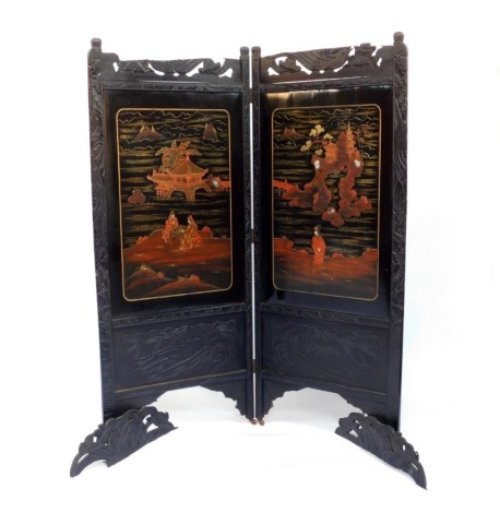 A late Victorian japanned lacquered two fold screen, carved with bamboo and decorated with landscapes and figures, raised on castors, 164cm high, 136cm wide. (AF)