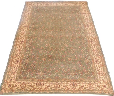 A Dunelm Oriental style green ground rug, decorated with flowers and arabesques, within floral borders, 230cm x 160cm.