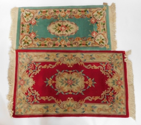 A Chinese red ground floral rug, 155cm x 90cm, and a similar Chinese blue ground rug, 146cm x 70cm. (2)