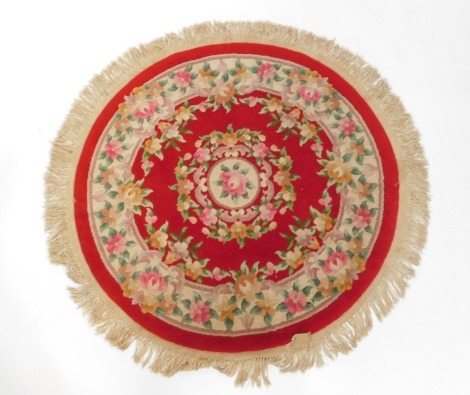 A Chinese red ground floral circular rug, 123cm diameter.