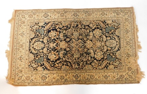 A Caucasian black ground rug, decorated with floral and arabesque motifs, within repeating floral borders, 192cm x 120cm.