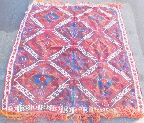 An Eastern inspired rug, formed as two runners with central joining, on a cream chequer banded border with blue and red central medallion design, 227cm x 141cm.