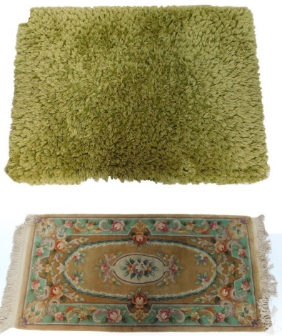 A Chinese cream ground floral rug, and a modern green wool pile rug. (2)