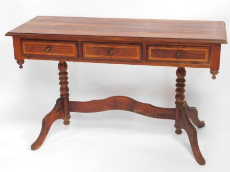 A South African blackwood with yellowwood inlay side table, with cross banding, having three frieze drawers, raised on turned columns over cabriole legs, united by an arched, shaped stretcher, 72cm high, 122c wide, 48cm deep.