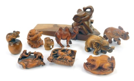 A group of carved wooden netsukes and other animal figures, to include frogs on leaf, elephant door stop, etc. (a quantity)