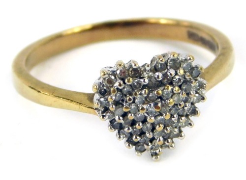 A 9ct gold love heart ring, set with tiny diamonds totalling 0.25ct overall, in a platinum claw setting on a yellow metal band, ring size Q½, 2.8g all in, boxed.