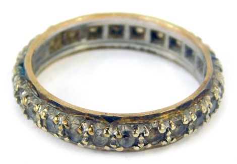 An eternity ring, set with cz, yellow metal stamped 9ct to sill, ring size Q, 3.6g all in.