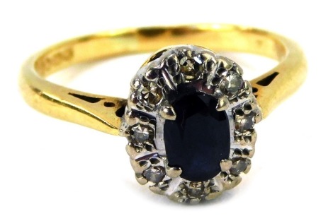 An 18ct gold sapphire and diamond cluster ring, the cluster set with oval sapphire in a claw setting surrounded by illusion set tiny diamonds, ring size I, 3.2g all in, boxed.