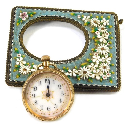 A Continental lady's pocket watch, the watch in a yellow metal casing, with scroll and blue enamel decoration with vacant shield, yellow metal stamped 14k, 25.5g all in, with a micro mosaic pocket watch frame, 17cm x 6cm. (2)