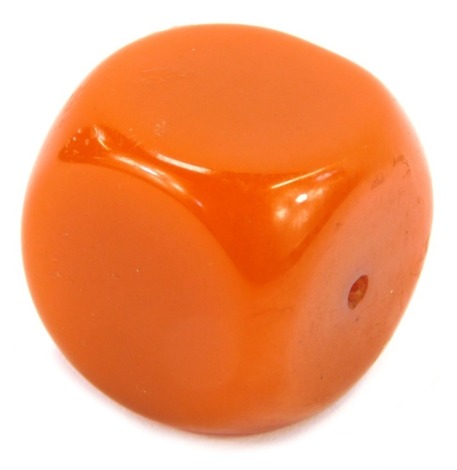 An African amber bead, with pierced centre, 2.5cm x 2.5cm, 30.8g all in.