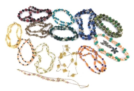 A group of semi precious stone set necklaces, comprising lapis, agate, coral, citrine, and others, each with yellow metal and white clasps and brakes.