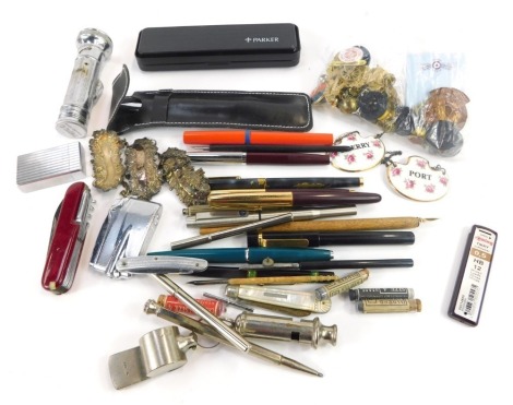 A group of ballpoint pens and fountain pens, inks, Pifco torch, an AR ACME policeman's whistle, mother of pearl penknife, small group of pin badges, etc. (1 tub)