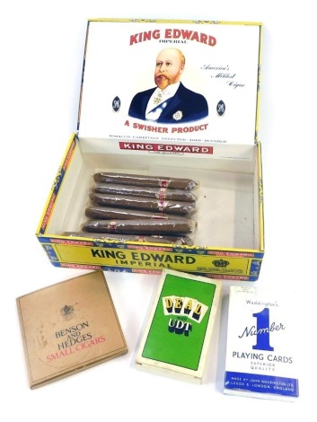 A case of King Edward Imperial Cigars, enclosing eight cigars, each wrapped, a part set of Benson & Hedges small Cigars (4), and two sets of playing cards.