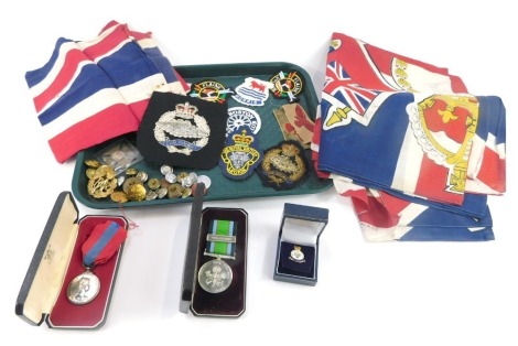 A Royal Mint Imperial Service Medal, named to Peter William Norman, cased, Battle for Britain Royal Airforce Memorial Medal, various Union Jacks and flags, shoulder and brass badges, military buttons, etc. (1 tray)