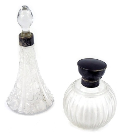 Two silver rimmed and cut glass perfume bottles, comprising a squat perfume bottle, with tortoise shell top and silver collar, 12cm high, and a cut glass squat perfume bottle with silver collar, 20cm high. (2)