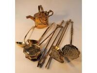 Two brass ladles, a brass chestnut warmer, three brass fire irons, brass