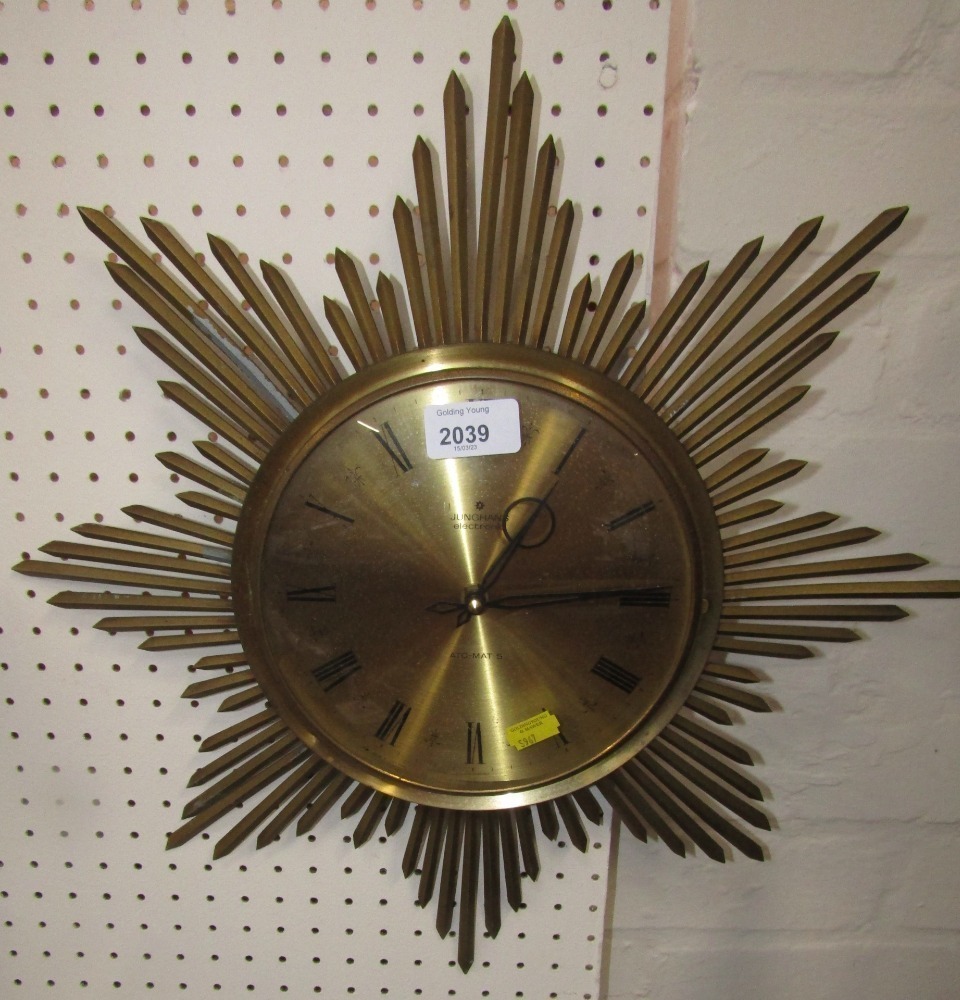 A Junghans electronic gold coloured star clock with a Roman