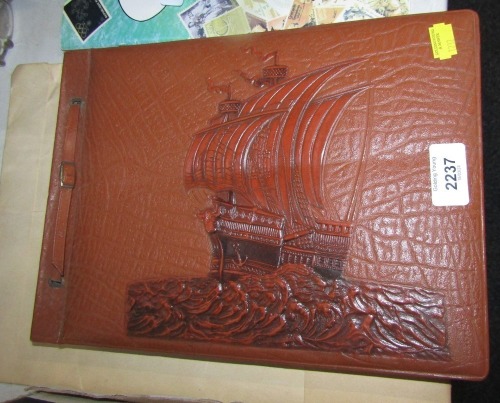 A leather embossed ship postcard album, lacking contents.