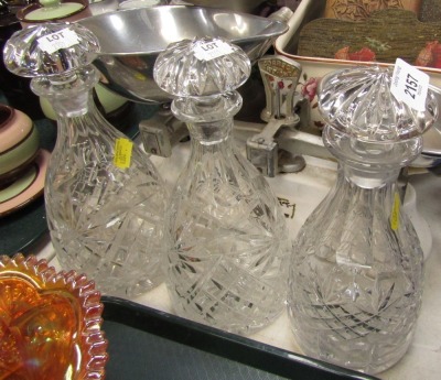 Three cut glass decanters and stoppers.