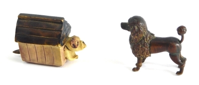 A 20thC novelty metal poodle tape measure, with articulated tail measure, and a further dog in kennel plastic novelty tape measure. (2)