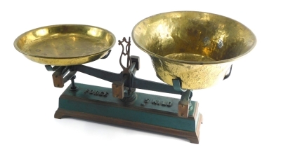 An early 20thC cast iron table scale, in green, on rectangular base marked Forge Five Kilo, on bracket feet, with two removable brass pans, 44cm wide.