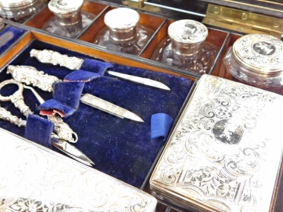 A 19thC coromandel travel box, the hinged lid revealing a mirror and fully fitted interior with a quantity of various implements, jars, and boxes, set with stag crests, the centre with files, scissors and button hook, with a secret front and side drawer, - 4