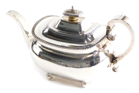 A George III silver teapot, by Thomas Johnson, of cape form with scroll handle, on orb feet, London 1811, 21.8oz,