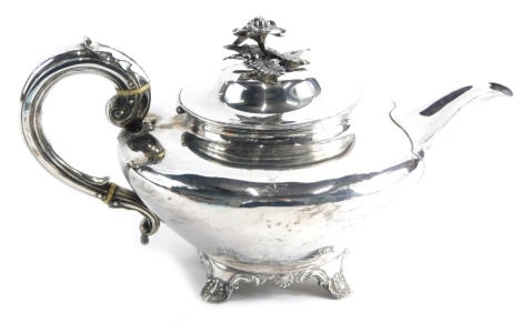 A George IV silver teapot, by Charles Fox II, with floral knop, acanthus leaf S scroll handle, circular body and scroll and shell feet, London 1833, 15cm high, 18oz.