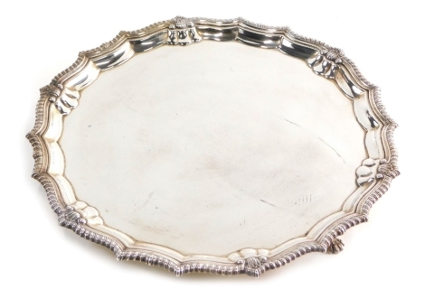 An Elizabeth II silver salver, by Parker Ellis Silver Co, piecrust and shell border, plain centre on triple hoof feet, Birmingham 1973, 26cm wide, 18.4oz.