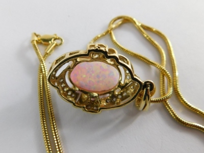 An opal and diamond pendant, the oval opal surrounded by twist design of tiny diamonds, in a raised basket setting, yellow metal unmarked, with Byzantine link neck chain stamped 585, the pendant 3cm high, the chain 42cm long, 8.7g all in. - 3