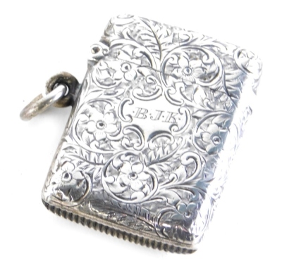 An Edward VII silver Vesta case, decorated with scrolls and flowers, with plain ring side, match strike base, with initialled cartouche, Birmingham 1907, 5cm high, 0.8oz.