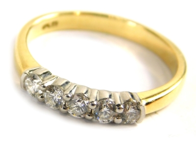 A 18ct gold diamond five stone dress ring, set with five round brilliant cut diamonds, each approx 0.08ct, in a platinum claw setting, on a yellow metal band, ring size N, 3g all in.