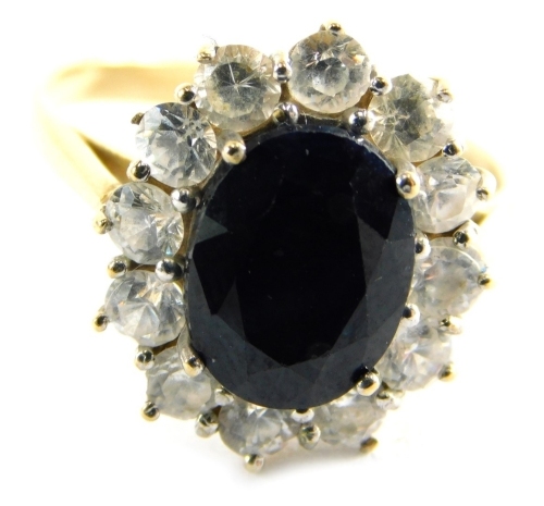 A 9ct gold cluster ring, set with central dark blue paste stone, surrounded by cz, in a raised basket setting, ring size M½, 3.9g all in.