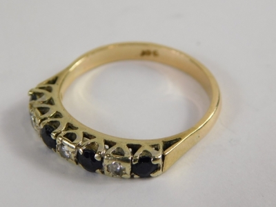 An 18ct gold sapphire and diamond half hoop dress ring, set with five round brilliant cut sapphires, each broken by two round brilliant cut diamonds, in a raised claw platinum setting, on a yellow metal band, ring size R½, 3.4g all in. - 4