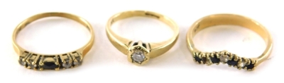 Three dress rings, comprising a wish bone ring with missing stone, yellow metal stand 9ct, a 9ct gold sapphire and cz dress ring yellow metal hallmarks rubbed and a 9ct gold diamond set solitaire, ring the diamond approximately 0.05 carats in a rub over p