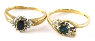 Two dress rings, comprising of a 9ct gold aquamarine and diamond twist ring, ring size N½ and a 9ct gold sapphire and diamond cluster ring, ring size K, 4.2g all in. (2, AF)