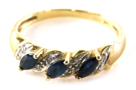 A 9ct gold dress ring, set with eight illusion set tiny diamonds and three marquise shaped blue/green coloured stones, ring size O, 2.3g all in.