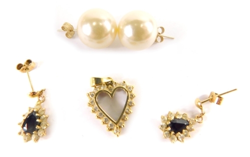 A group of earrings and pendants, comprising a 9ct gold heart shaped pendant, set with czs, a pair of cultured pearl and yellow metal stud earrings, unmarked, and a pair of paste stone set 9ct gold drop earrings, 5.6g all in. (5)
