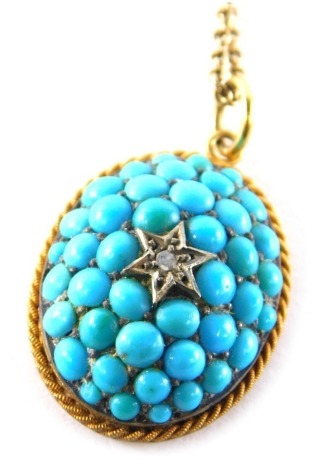 An Edwardian oval turquoise pendant, of raised design with central diamond and star setting, surrounded by turquoise beads, 2.5cm x 1.5cm, in a silver gilt frame, on a plated chain, 42cm long, 9.7g all in.