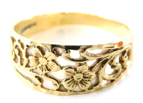 A 9ct gold dress ring, of half hoop design with pierced design of flowers, ring size R, 2.4g all in.