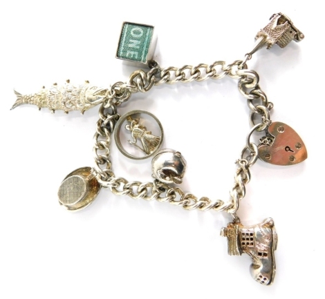 A silver charm bracelet, with curb link bracelet set with seven charms, safety chains and padlock, 18cm long, 54.9g all in.