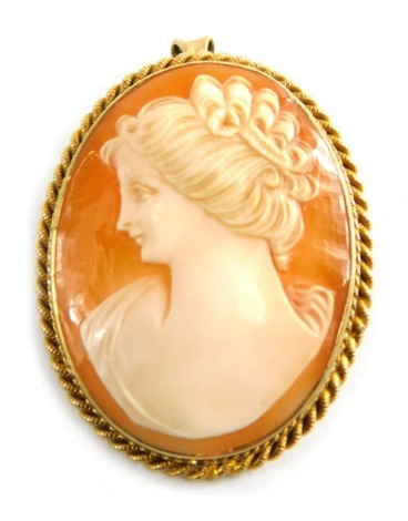 A 9ct gold framed shell cameo brooch, with rope twist border, on single pin back, 3cm x 4cm, with pendant attachment, 11.1g all in.