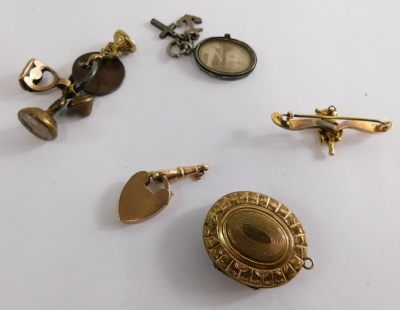 A group of 9ct gold and other jewellery, comprising a 9ct gold heart shaped locket and curb clasp, a 9ct gold Lincoln Imp bar brooch, 4cm wide, 5.2g all in, a set of gilt metal seal fobs, silver partial locket and a plated locket. (a quantity) - 3