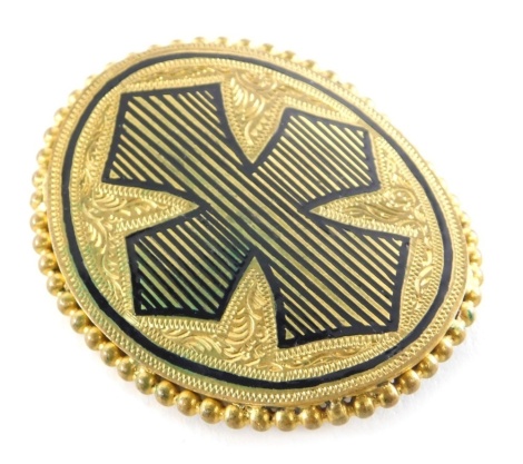 An Edwardian Pinchbeck nurse's buckle, of oval design, with black enamel cross and beaded border, 6cm x 4.5cm.