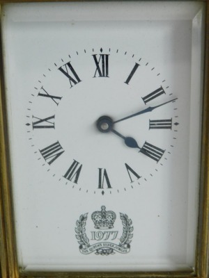 A 20thC Silver Jubilee brass carriage clock, with Royal Crest to the 6cm wide Roman numeric dial, in a five part glazed case, with barrel movement on bracket feet, with swing handle, 14cm high. - 2