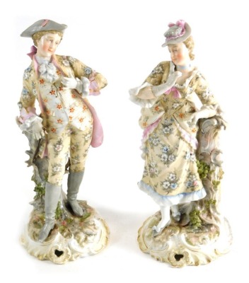 A pair of early 20thC Sitzendorf door figures of a lady and gentleman, each in flowing floral robes, on a naturalistic gilt lined base, blue line mark beneath, 27cms high. (2)